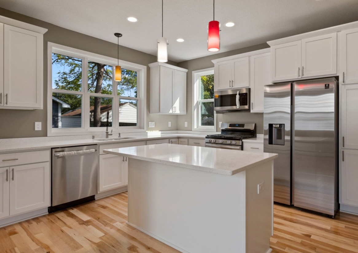 Newly remodeled kitchen with white cupboards and countertops