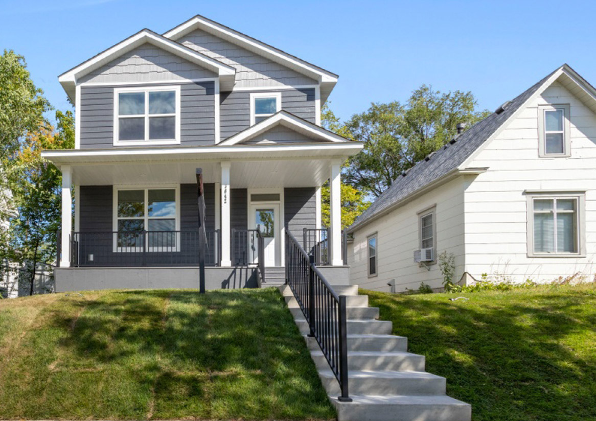 A two-story gray house with a front porch